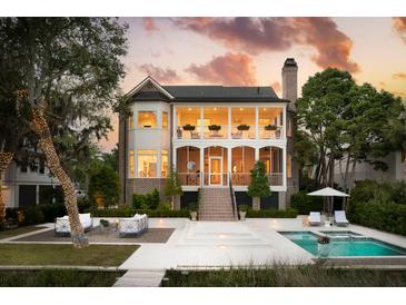 Stunning two-story brick home featuring a covered porch, pool, and lush landscaping at 80 On The Harbor Dr, Mount Pleasant, SC 29464