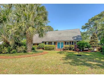 Charming single-story brick home with a lush, landscaped front yard and inviting blue double doors at 968 Cummings Cir, Mount Pleasant, SC 29464