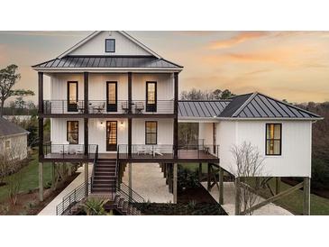 Stunning 3 story home with a metal roof, grand staircases, and beautiful decks and patios at 000 Remington Trl, Johns Island, SC 29455