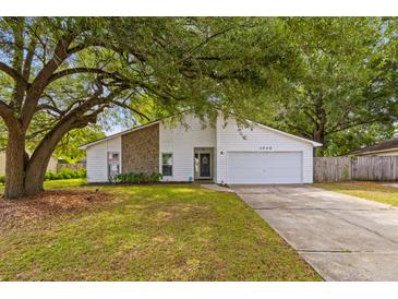 Charming single-Gathering home with white siding, stone accents, and a spacious two-car garage at 1024 Willowood Ave, Goose Creek, SC 29445