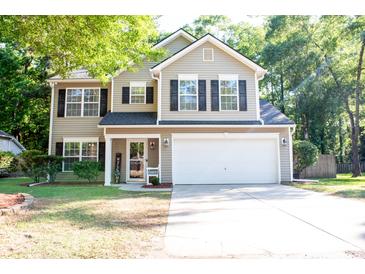 Charming two-story home with a manicured lawn, a two-car garage, and classic architectural details at 109 Holly St, Summerville, SC 29485