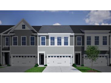 Charming townhome featuring gray siding, a two-car garage, and a well-maintained lawn with a young tree at 122 Brown Swiss Circle, Summerville, SC 29483
