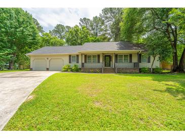Charming single-story home with a well-manicured front lawn and attached two-car garage at 136 Harrow Pl, Goose Creek, SC 29445