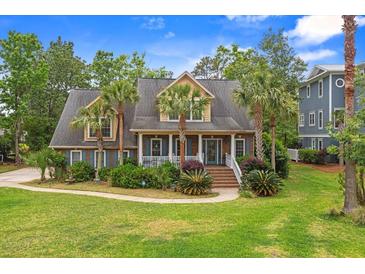 Charming home with palm trees, well-maintained lawn, and inviting front porch at 1721 Bowline Dr, Mount Pleasant, SC 29466