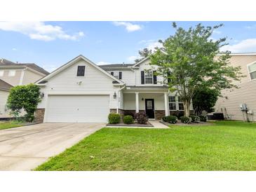 Charming two-story home featuring a two-car garage, well-manicured lawn, and welcoming front porch at 218 Austin Creek Ct, Summerville, SC 29483