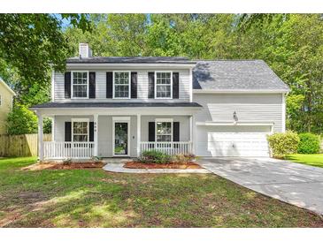 Charming two-story home featuring a welcoming front porch, well-maintained lawn, and attached garage at 240 Eagle Ridge Rd, Summerville, SC 29485