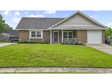 Charming single-story brick home with a well-maintained lawn and attached garage at 313 Janice St, Goose Creek, SC 29445