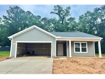 Charming gray home with open garage, covered entrance, and well-lit window at 4147 Rising Tide Dr, Summerville, SC 29485