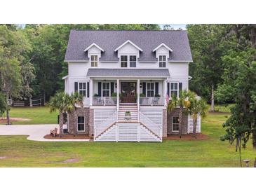 Charming two-story home with a welcoming porch and a beautifully landscaped front yard at 4205 Cobble Trot Way, Johns Island, SC 29455