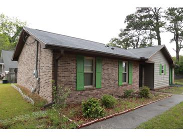 Charming brick home with green shutters and a well-maintained landscape at 814 Armsway St, Mount Pleasant, SC 29464