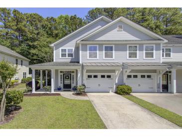 Charming gray townhome with a well-manicured lawn, covered front porch, and two-car garage at 9624 Scarborough Ct, Summerville, SC 29485
