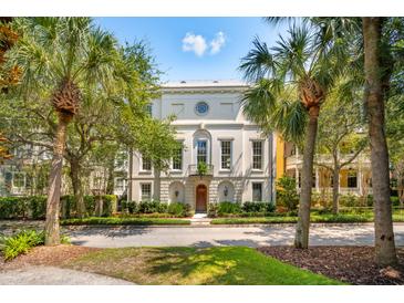 Stately home exterior featuring an elegant facade, mature trees, and a meticulously landscaped lawn at N Blvd, Mount Pleasant, SC 29464