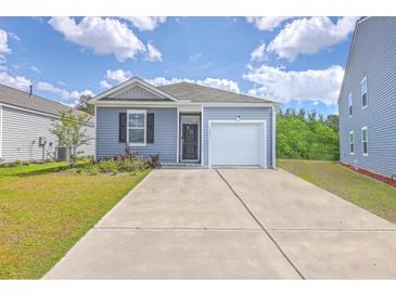 Charming single-Gathering home with a garage and a well-maintained lawn on a sunny day at 1003 Peridote Way, Ladson, SC 29456