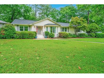 Charming home with a lush green lawn and well-manicured landscaping at 1035 Planters Curve, Mount Pleasant, SC 29464
