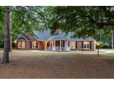 Charming brick home with a covered front porch and manicured lawn at 111 Coltsgate Ct, Summerville, SC 29485