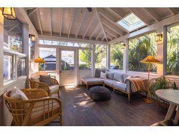 Inviting sunroom with vaulted ceilings, skylights, and cozy seating, perfect for relaxation and enjoying natural light at 1153 King St, Charleston, SC 29403