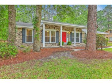 Charming brick home with a bright red front door and a cozy, inviting porch at 206 Jimbo Rd, Summerville, SC 29485