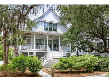 Charming two-story home featuring a welcoming front porch, white railings, and lush landscaping at 3305 Knot Aly, Johns Island, SC 29455