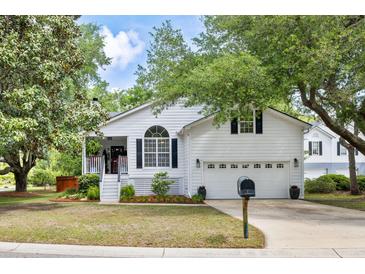 Charming white two-story home with an attached two-car garage and a well-manicured front lawn at 638 Stono Edge Dr, Charleston, SC 29412
