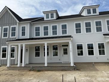 New construction townhouse featuring gray siding, a front porch with white columns, and multiple windows at 760 Blueway Ave, Summerville, SC 29486