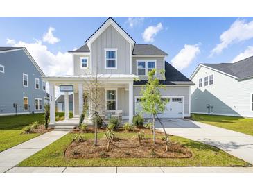 Charming two-story home with a landscaped yard and inviting front porch at 104 Snow St, Summerville, SC 29486