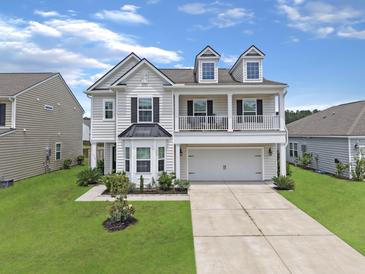 Charming two-story home with a welcoming front porch and well-manicured lawn at 115 Daniels Creek Cir, Goose Creek, SC 29445