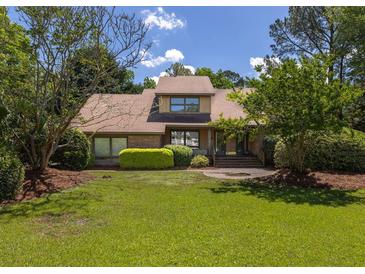 Charming home with lush green lawn, mature trees, and well-maintained landscaping, creating great curb appeal at 1218 Chersonese Round, Mount Pleasant, SC 29464