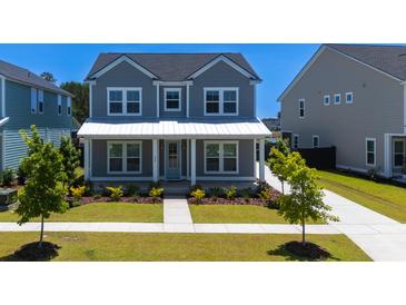 Charming two-story home features a landscaped yard, a welcoming front porch and a light blue front door at 232 Ashworth Dr, Summerville, SC 29486