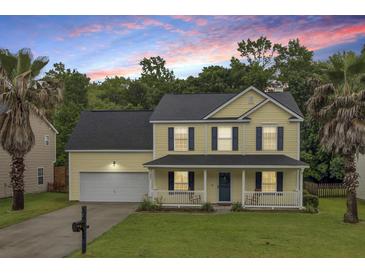 Charming two-story home featuring a welcoming front porch, two-car garage, and beautiful landscaping at 327 Eagle Ridge Rd, Summerville, SC 29485