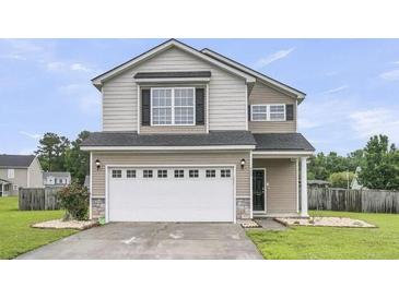 Inviting two-story home with neutral siding, a two-car garage, and well-maintained landscaping at 423 Watershed Dr, Goose Creek, SC 29445