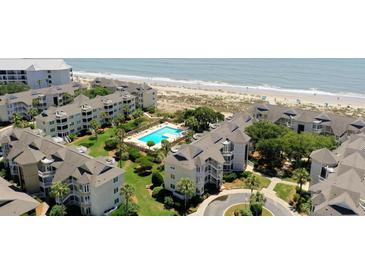 Beautiful aerial view of the property, community pool, and pristine beach at 9000 Palmetto Dr # C104, Isle of Palms, SC 29451