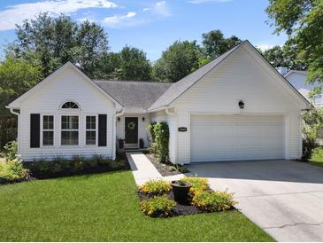Charming single-story home with white siding, black shutters, and a well-manicured lawn at 1048 Wayfarer Ln, Charleston, SC 29412