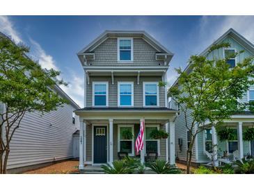 Charming two-story home with a welcoming front porch and well-maintained landscaping at 1061 Ashley Gardens Blvd, Charleston, SC 29414