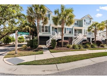 Charming townhomes boast a coastal aesthetic with palm trees and well-maintained landscaping at 2200 Hamlin Sound Cir, Mount Pleasant, SC 29466
