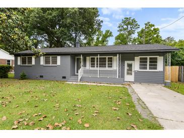 Charming gray brick ranch-style home with well-maintained front yard, walkway and covered porch at 323 Amy Dr, Goose Creek, SC 29445