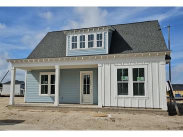 Charming single-story home showcasing a welcoming porch, light blue siding, and white trim under a gray shingled roof at 363 Trailmore Ln, Summerville, SC 29486
