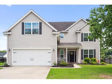 Charming two-story home with a well-manicured lawn, white garage door and black shutters at 428 Cabrill Dr, Charleston, SC 29414