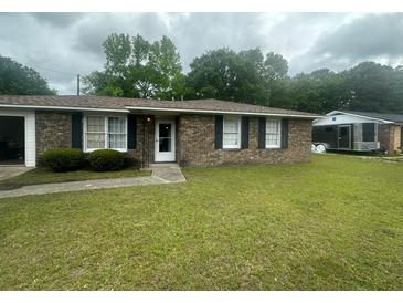 Charming single-story brick home featuring a well-maintained lawn and classic black shutters at 4462 Hardwood St, Ladson, SC 29456