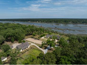 Stunning aerial view of the horse farm and home nestled along the water at 4855 Retriever Rd, Wadmalaw Island, SC 29487