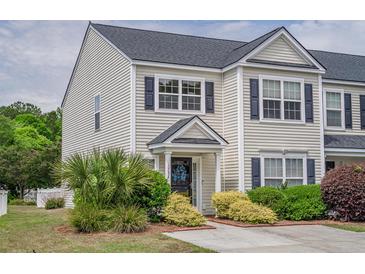 Charming townhome featuring neat landscaping, dark shutters, and a welcoming front entrance at 1003 Washitonia Way # A, Charleston, SC 29492