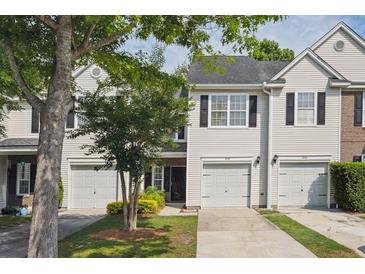 Charming townhouse featuring a one-car garage and tidy landscaping at 1054 Bennington Dr, Charleston, SC 29492