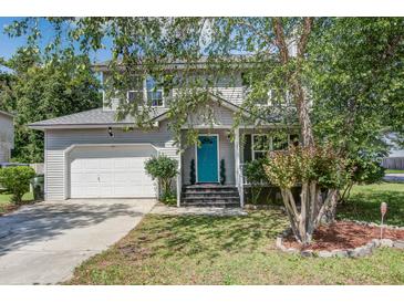 Charming two-story home with a light gray exterior, a blue front door, and well-maintained landscaping at 137 Ashton Dr, Goose Creek, SC 29445