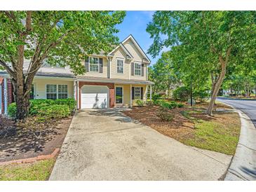 Charming two-story home with a manicured lawn and inviting front entrance, complemented by lush trees at 149 Darcy Ave, Goose Creek, SC 29445