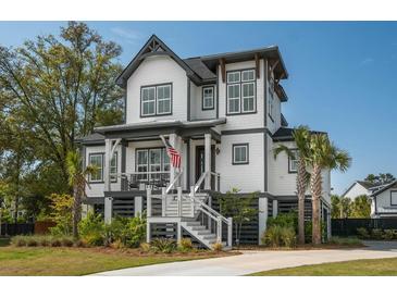 Charming two-story home with landscaped yard, porch, and stairs leading to the front door at 1537 Tomato Farm Cir, Mount Pleasant, SC 29464