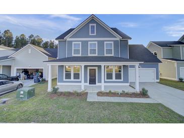 Charming two-story home with a covered front porch and well-maintained landscaping at 199 Belfort Pl, Summerville, SC 29486
