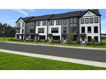 Charming row of townhomes featuring a modern black and white color scheme and well-manicured lawns at 207 Somerset Acres Dr, Summerville, SC 29486