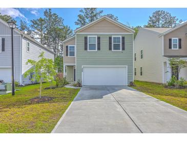 Charming two-story home with a well-manicured lawn and a two-car garage in a friendly neighborhood at 260 Sweet Cherry Ln, Summerville, SC 29486