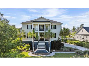 Charming two-story home featuring a double front porch, white columns and professionally landscaped yard at 3011 River Vista Way, Mount Pleasant, SC 29466