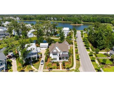 Stunning aerial view of a traditional home with lush landscaping, a pond and community lake views at 3741 Juneberry Ct, Mount Pleasant, SC 29466
