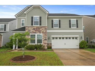 Two-story home featuring stone accents and a two-car garage at 700 Silver Moss Dr, Moncks Corner, SC 29461